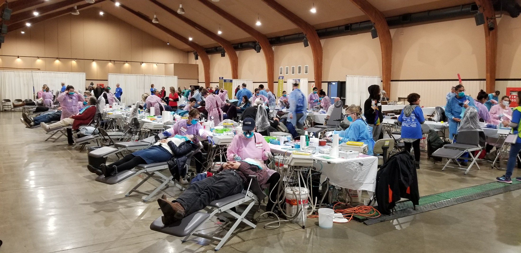 Multiple people receiving dental services during community outreach program